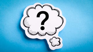 A paper, cloud-shaped cut out with a cloud containing a question mark drawn in the middle. It's hovering above sky-blue background.