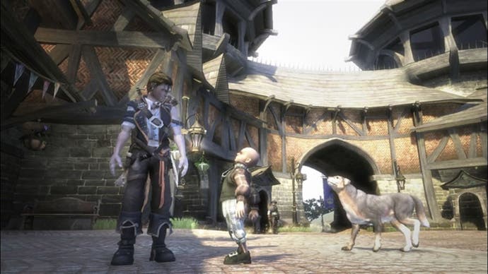 A Fable 2 screenshot showing a male player character conversing with a boy in a village while his dog wanders up behind.